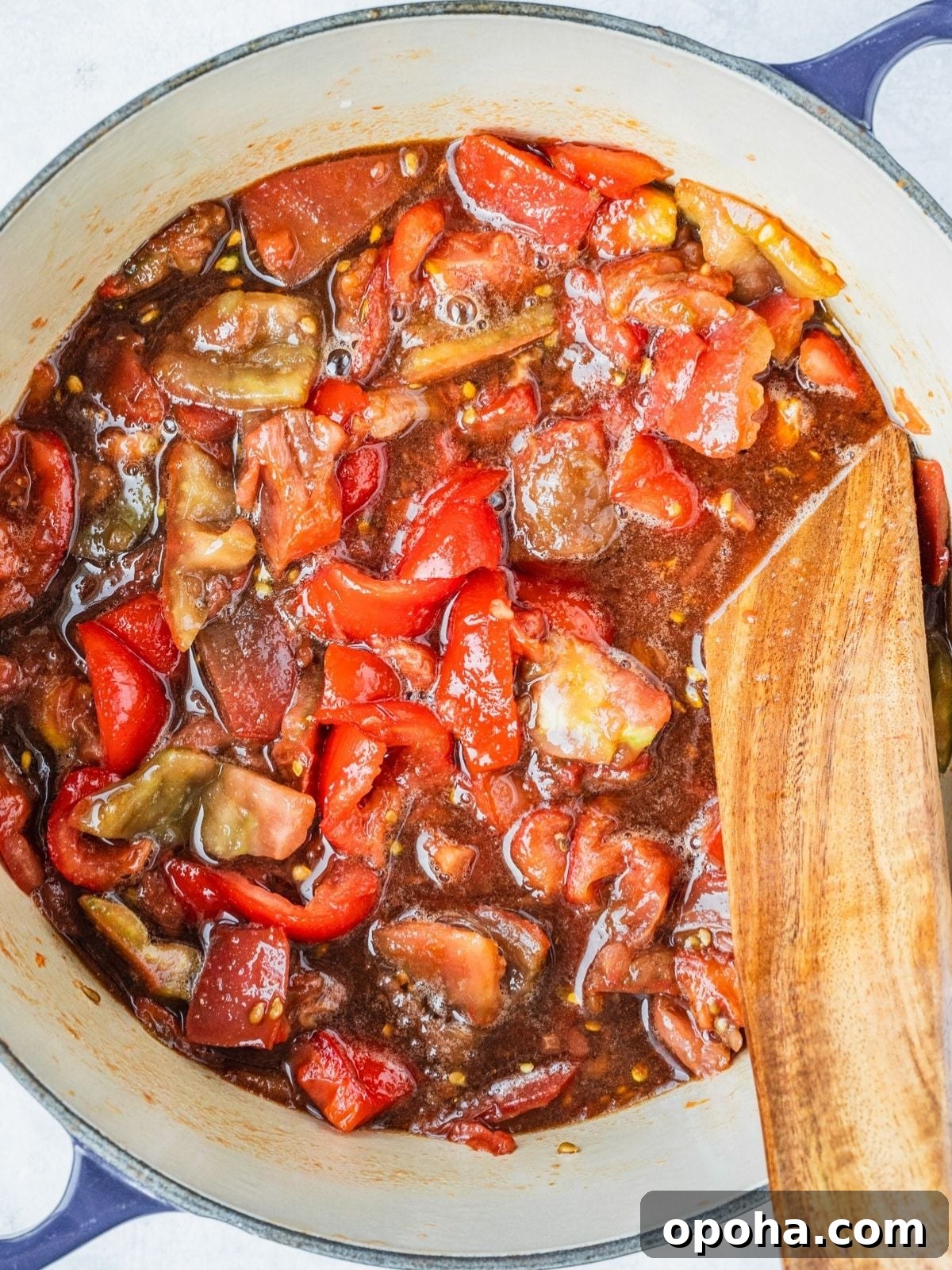 Pot with chunks of tomatoes, sugar, spices and vinegar right after first boil.