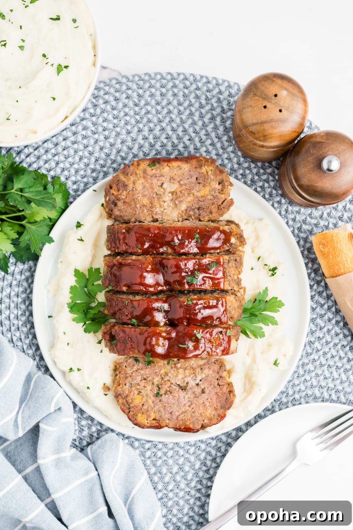 Sliced up meatloaf on a plate.