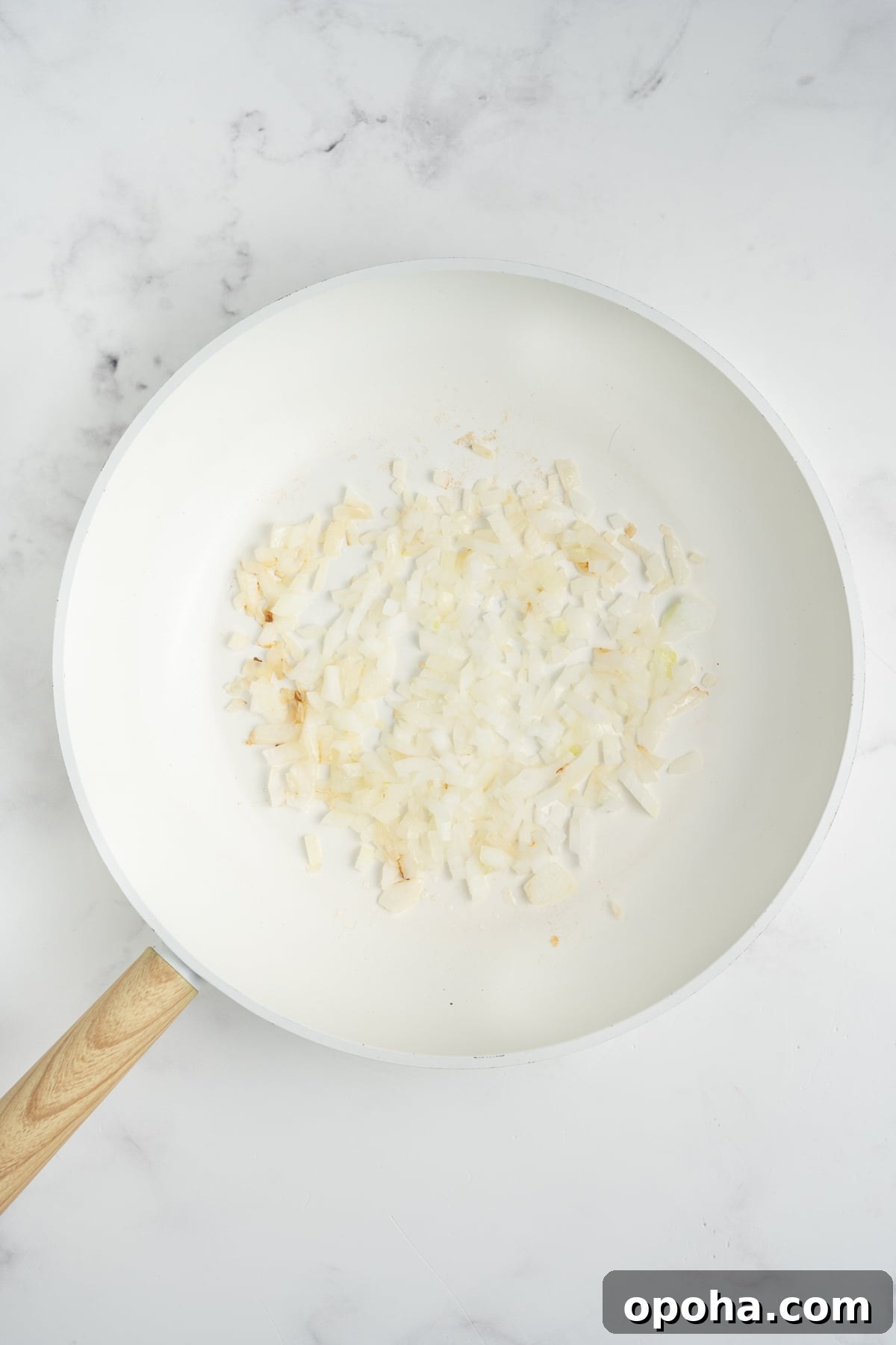 Onions sauteing in a pan.