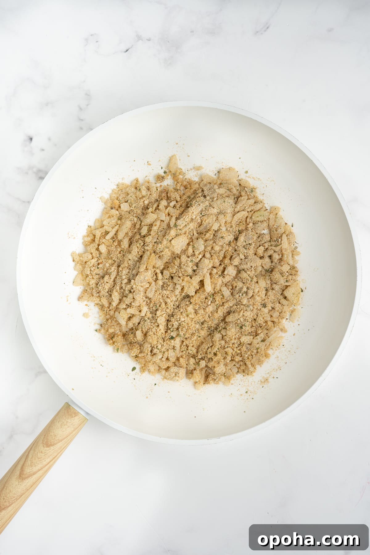 Breadcrumbs added into the skillet.