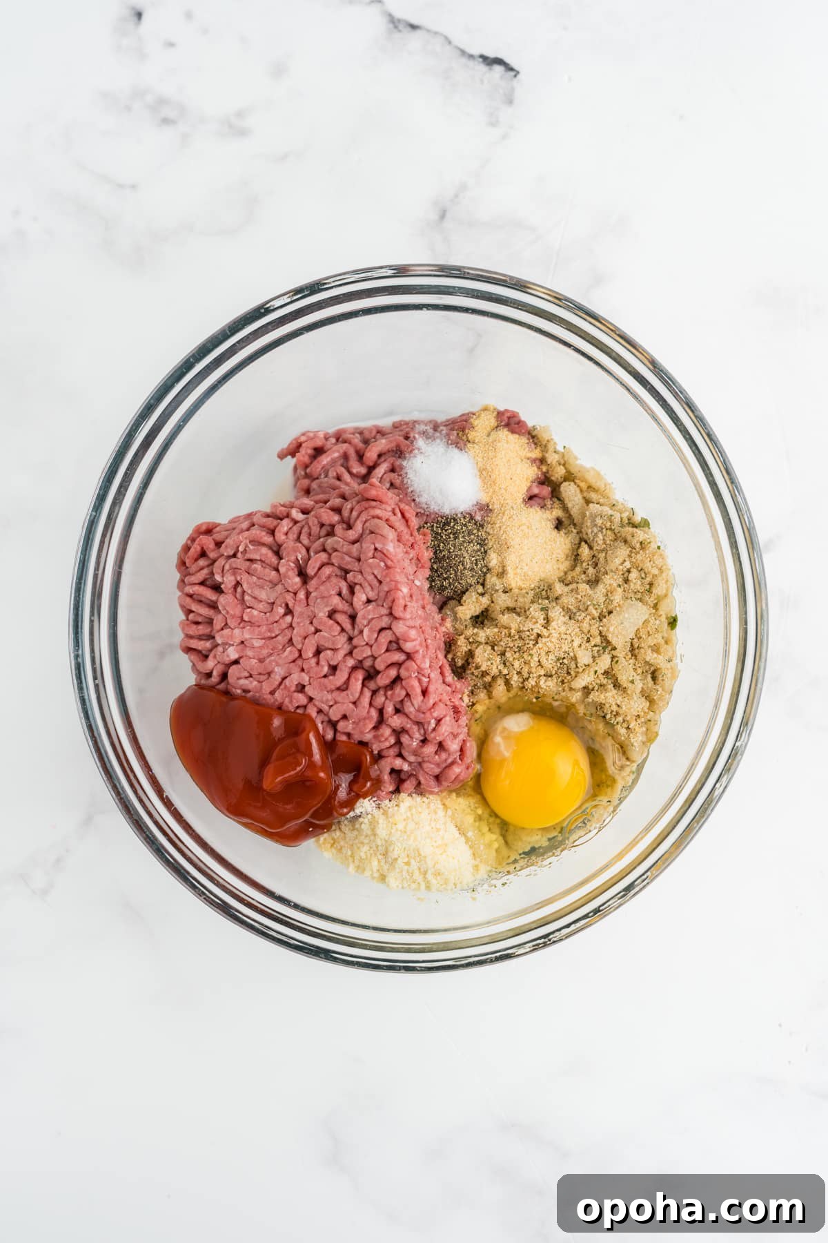 The meatloaf ingredients into the bowl.