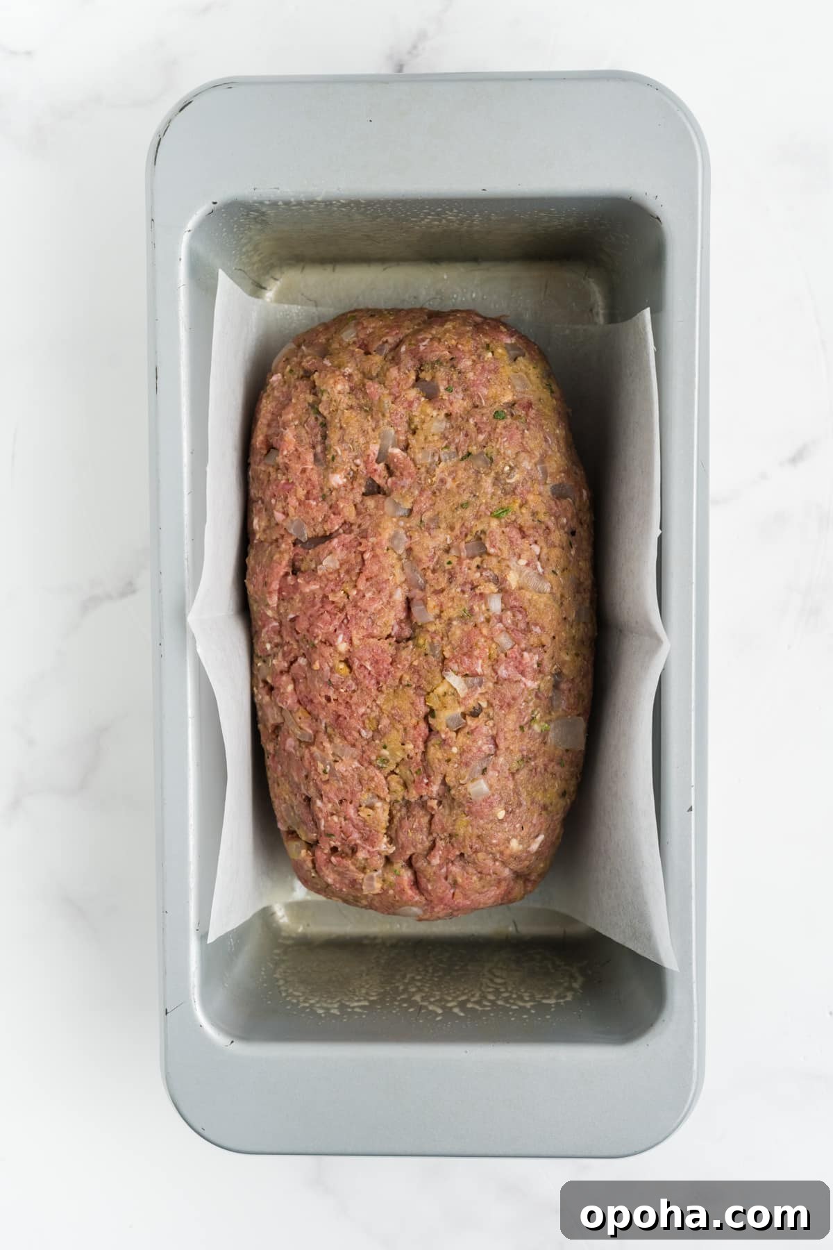 The meat mixture in a loaf pan.