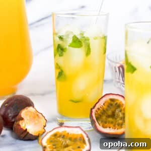 Fresh Passion Fruit Juice Recipe: Tangy Homemade Drink 8 Two cups of passion fruit juice garnished with ice and mint next to purple passion fruit
