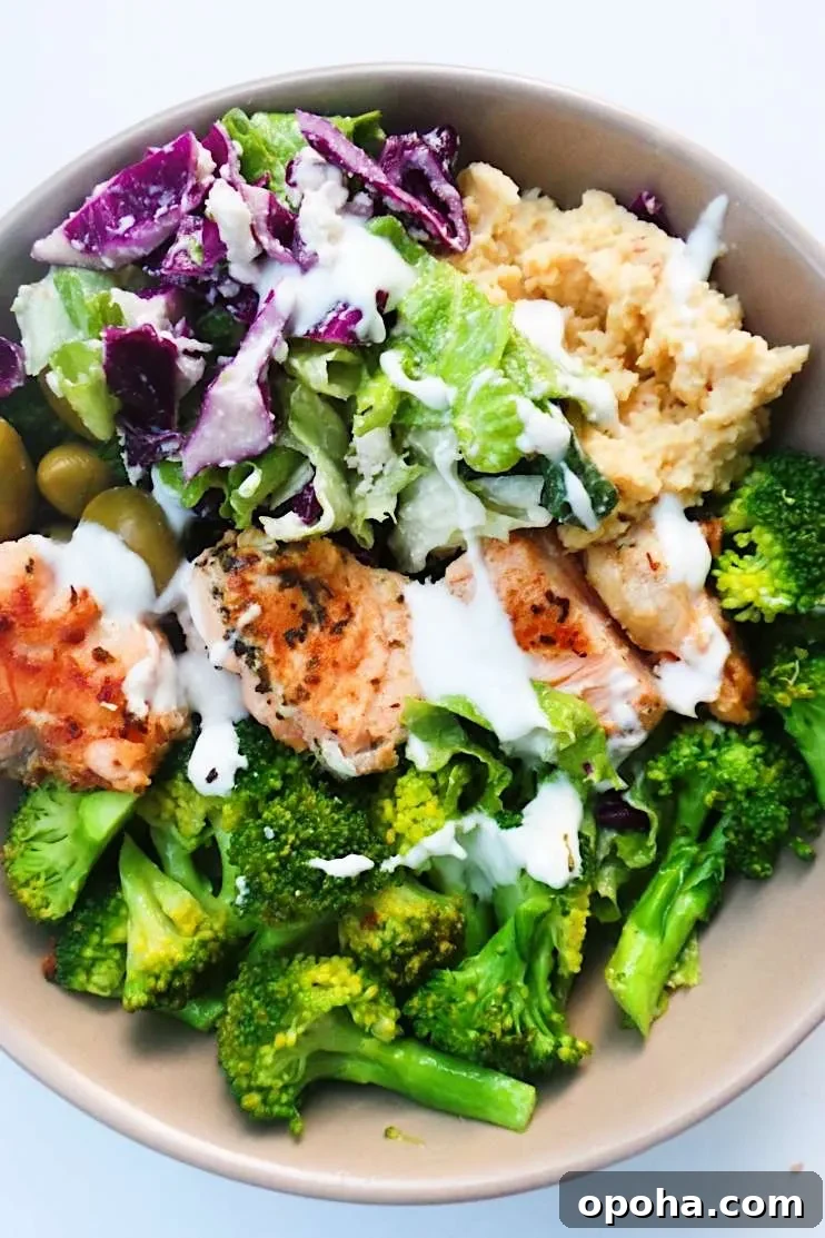 Mediterranean Salmon Bowl - a healthy dinner idea that is easy, full of flavor, super satisfying and ready in less than 30 minutes! This healthy salmon recipe comes with a meal prep option and can easily be made keto and low carb by using low-carb zucchini hummus (recipe provided). | clean eating dinner recipe