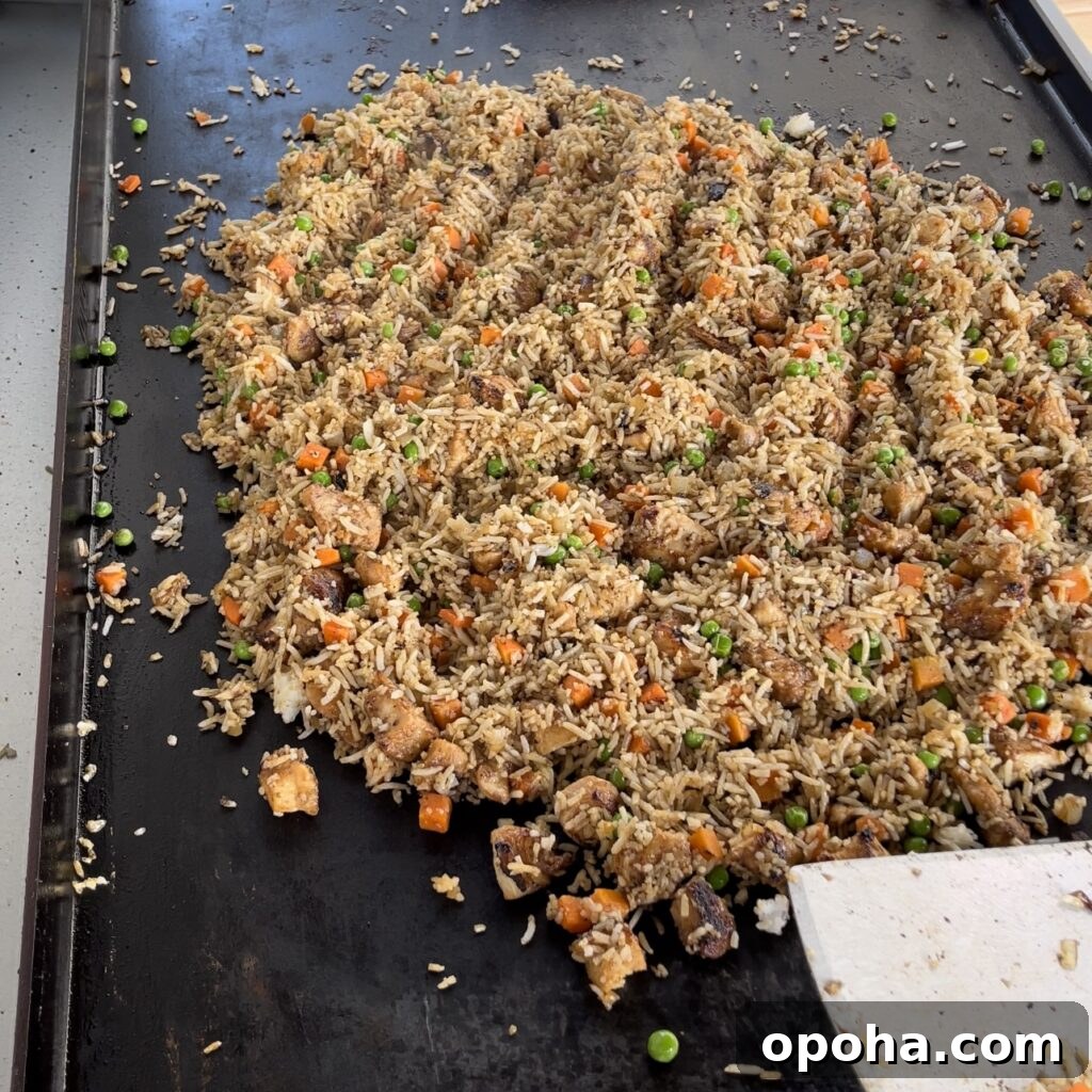 Fried rice with eggs and butter on griddle