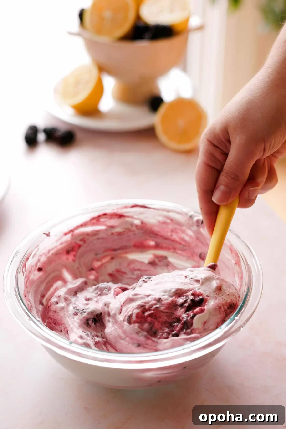 folding macerated blackberries into whipping cream