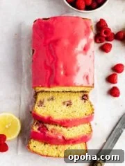 lemon raspberry loaf sliced with raspberry glaze on wax paper