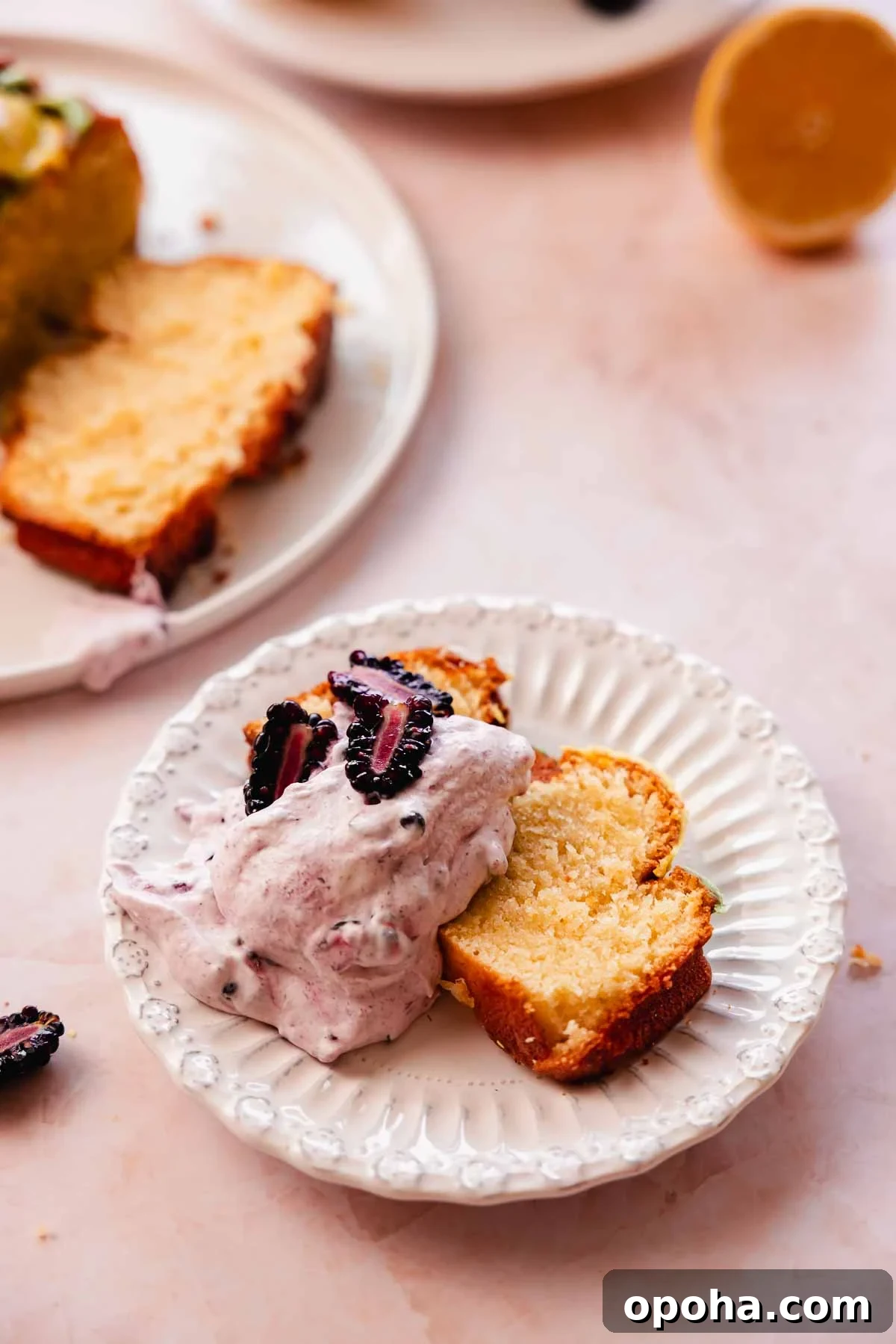 slice of lemon pound cake with blackberry whipped cream