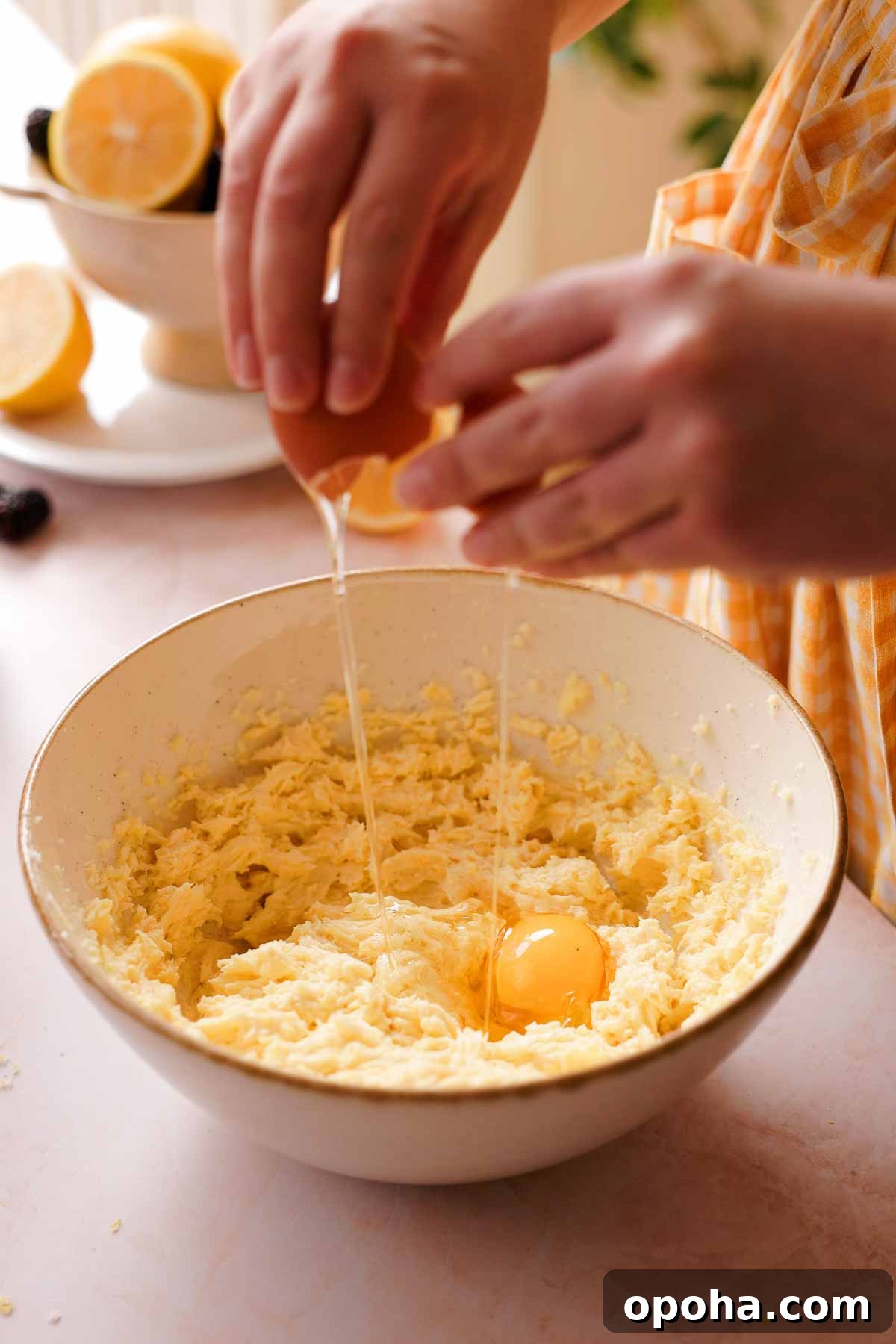adding one egg into lemon pound cake batter