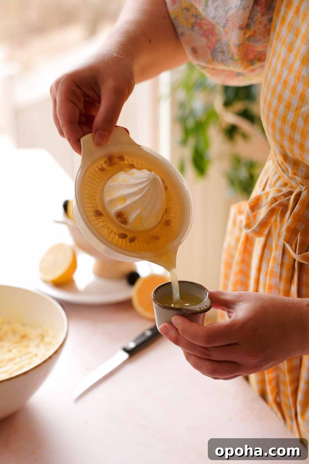 pouring lemon juice into measuring cup