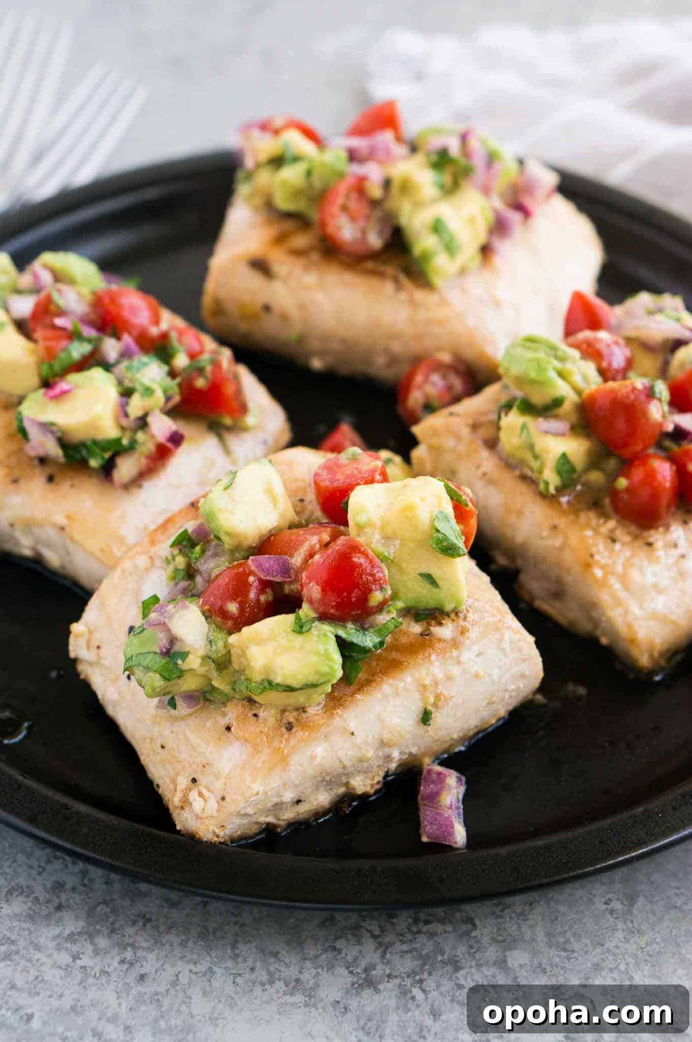 pan seared white fish with avocado salsa on a plate