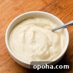 vanilla bean custard cream in a white bowl with a spoon