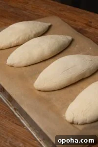 Unbaked elongated dough pieces on parchment