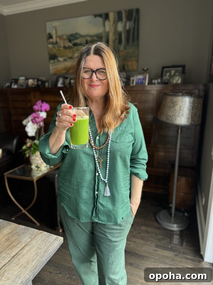 Teri wearing all green while drinking a green juice