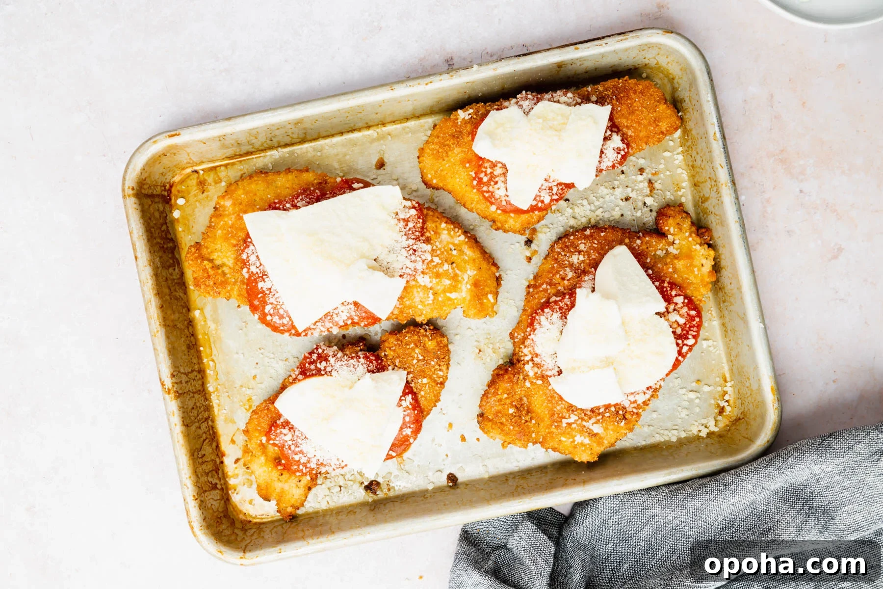 Crispy Gluten-Free Chicken Parmesan Recipe for Dinner 12 A tray of assembled gluten-free chicken parmesan ready for the oven.