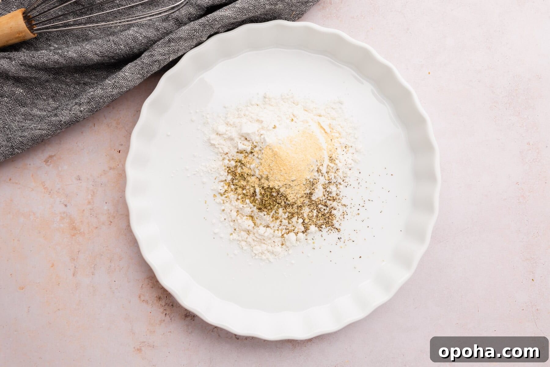 Crispy Gluten-Free Chicken Parmesan Recipe for Dinner 8 A bowl of gluten-free flour blend, salt, pepper, Italian seasoning, and garlic powder.