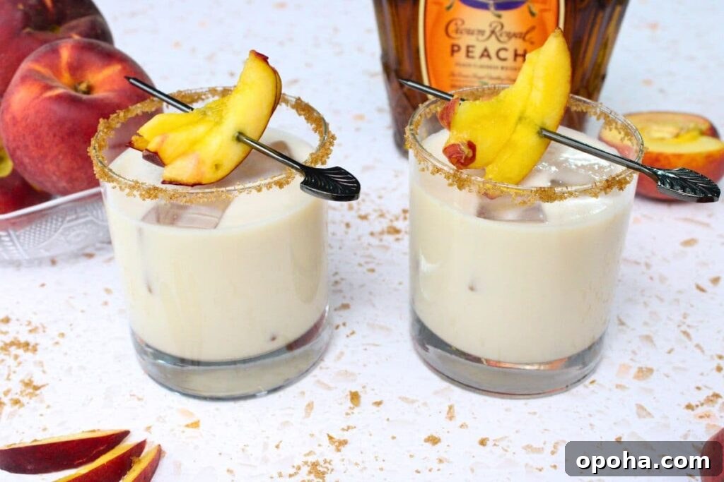 Peach Cobbler Cocktail Recipe with Crown Royal Whiskey 3 two peach cobbler cocktails in front of crown royal bottle