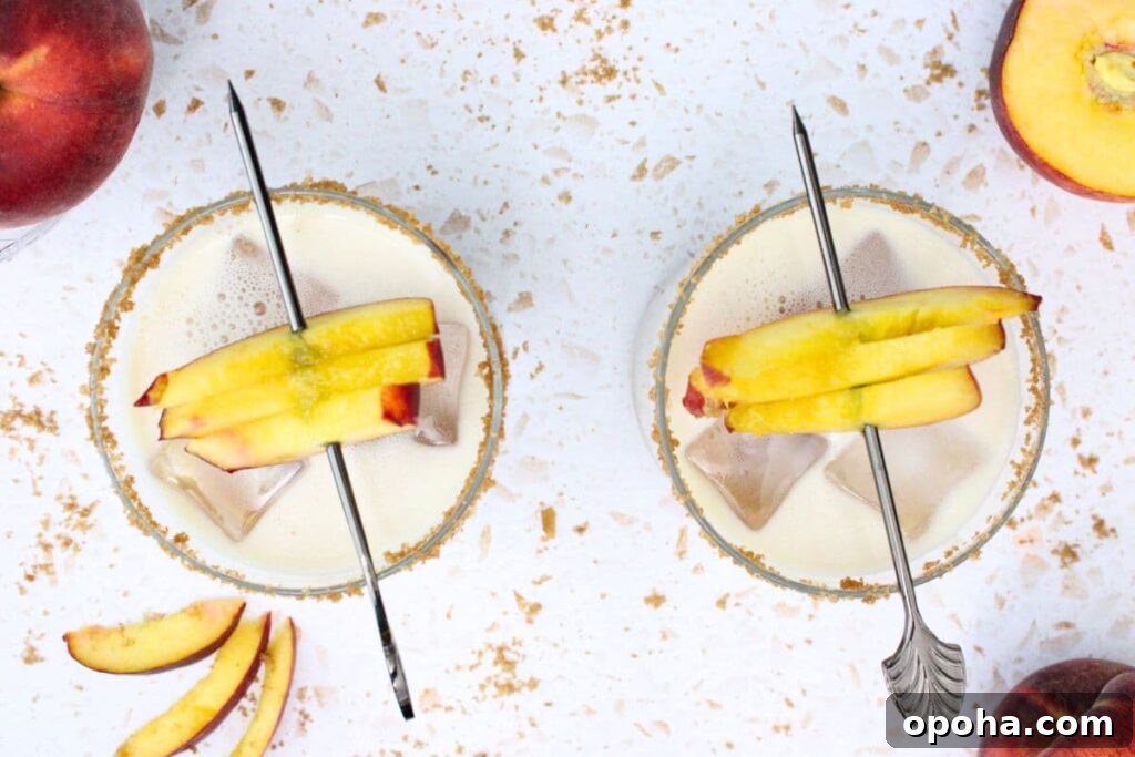 Peach Cobbler Cocktail Recipe with Crown Royal Whiskey 8 overhead view of two crown royal peach cobbler cocktails with fresh peach slice skewers