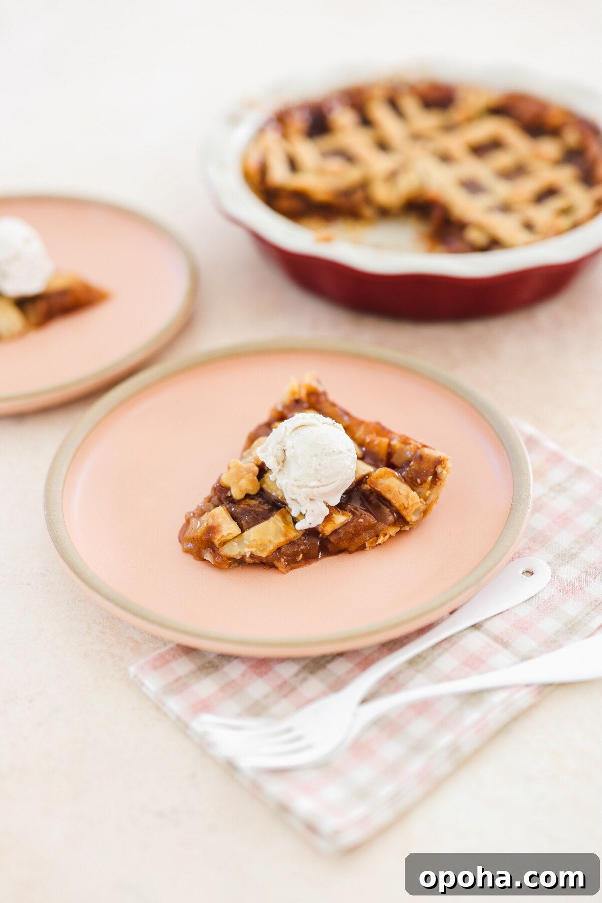 Vegan Miso Caramel Apple Pie Recipe for Cozy Fall Desserts 2 a slice of miso caramel apple pie on a pink plate with a scoop of ice cream