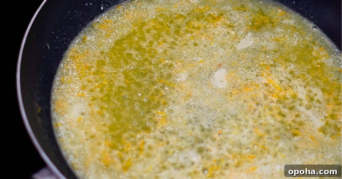 boiling orange zest, orange juice, lemon juice, sugar, and butter in a frying pan