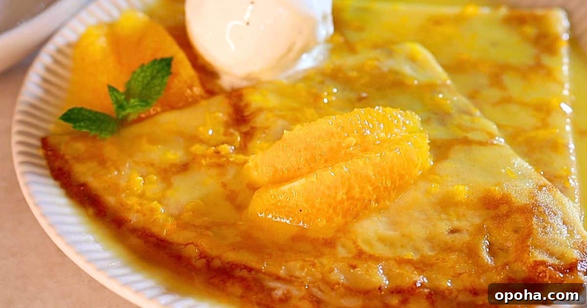 easy homemade crepes suzette on a plate with vanilla ice cream
