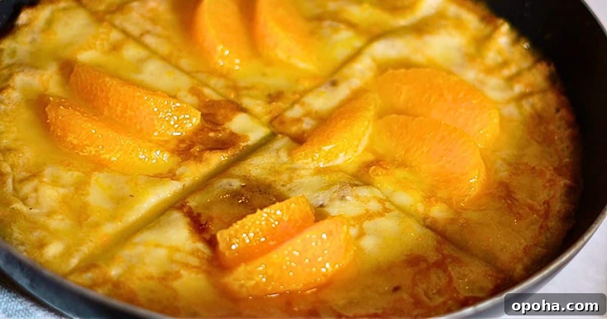 warm crepes suzette with orange sauce on a frying pan