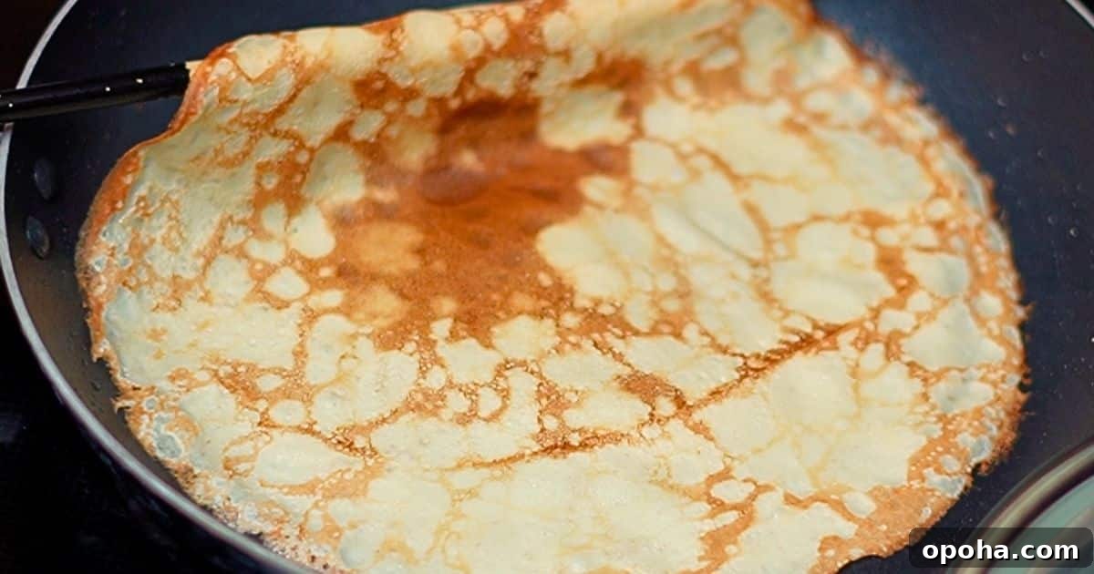 cooking a homemade crepe with a hot skillet