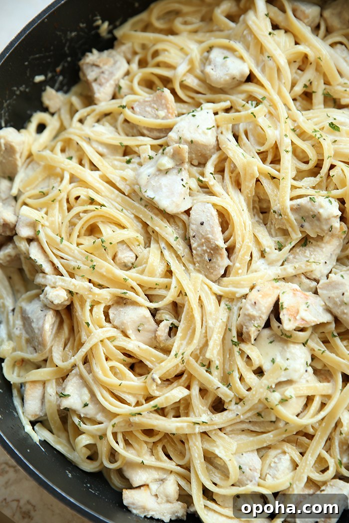 A large skillet of lemon chicken pasta.