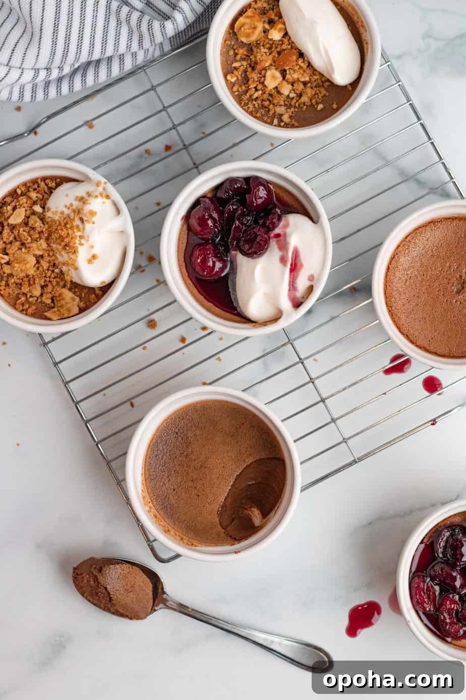 Chocolate Pots de Crème: Two Delicious Ways to Make Them 2 chocolate pots de cremes in white ramekins with pretzel crumble or bourbon cherries on top