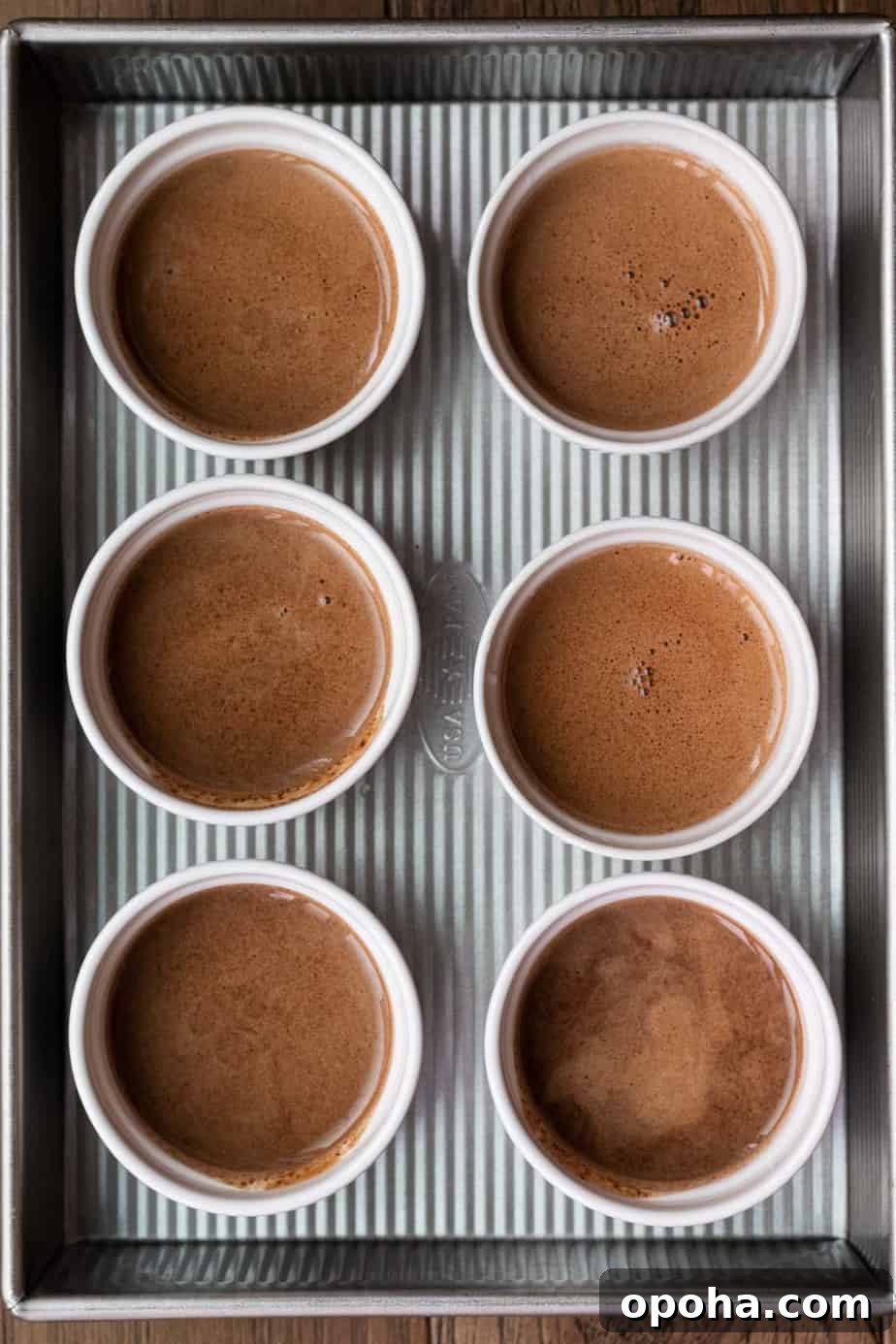 Chocolate Pots de Crème: Two Delicious Ways to Make Them 3 6 white ramekins with unbaked chocolate pot de creme in baking pan