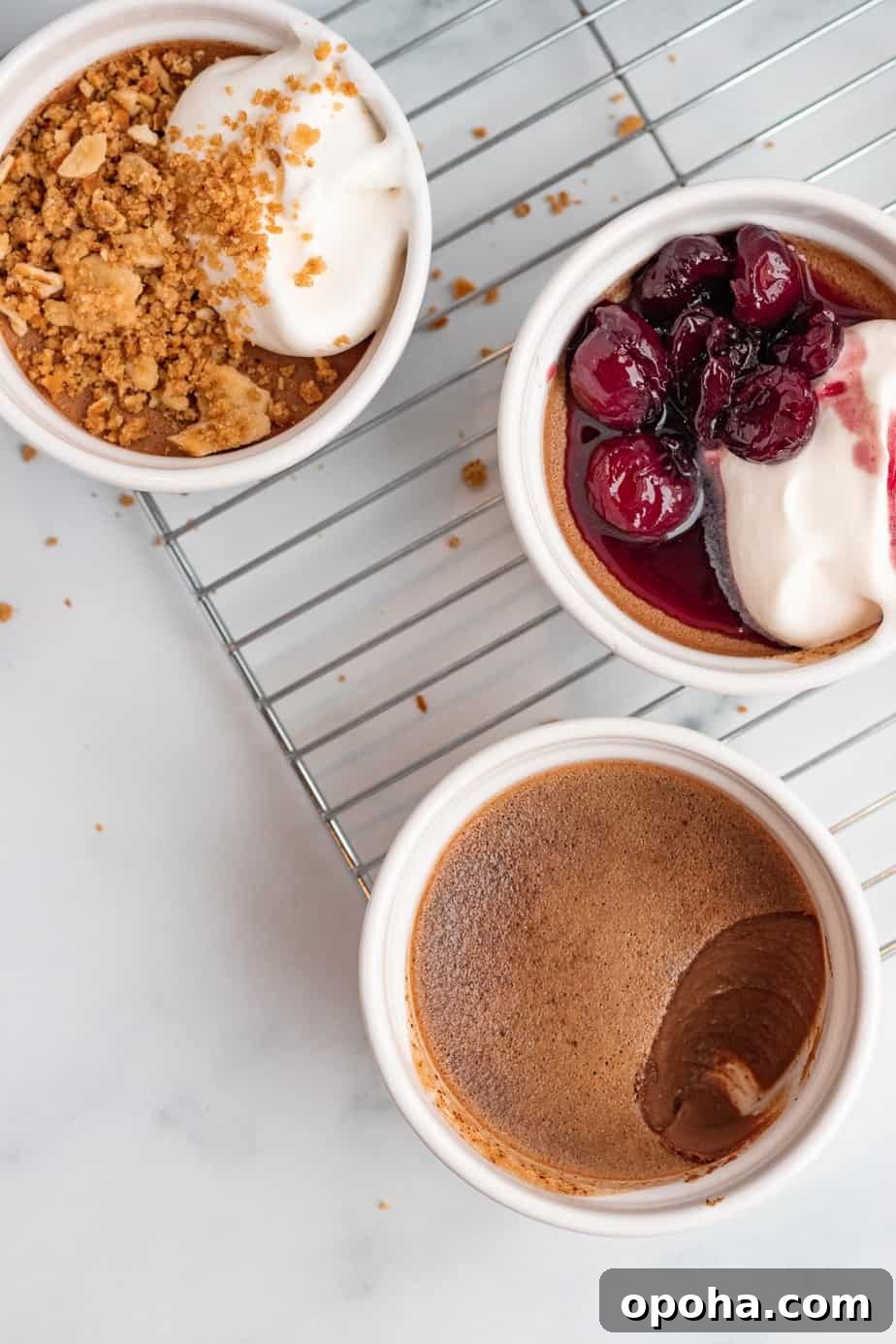 Chocolate Pots de Crème: Two Delicious Ways to Make Them 4 3 chocolate pots de creme on baking rack. One with bourbon cherries and one with peanut butter pretzel crumble.