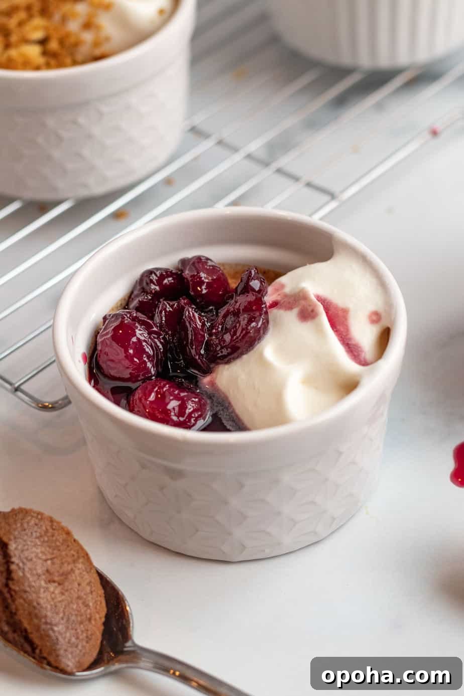 Chocolate Pots de Crème: Two Delicious Ways to Make Them 5 chocolate pots de creme with cherries on top in foreground and pretzel crumble on top in background