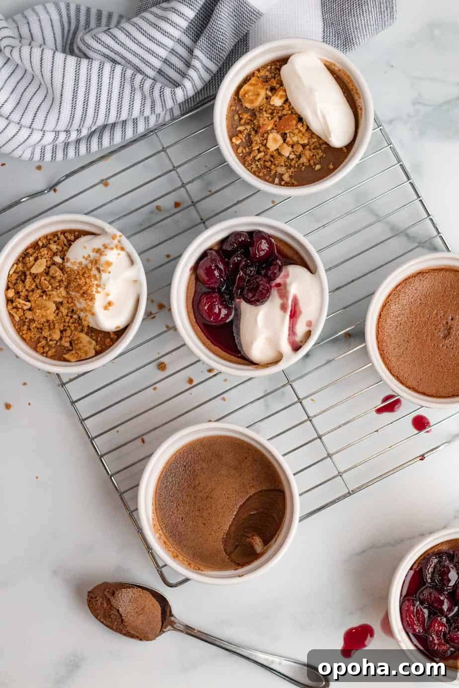 chocolate pots de cremes in white ramekins with pretzel crumble or bourbon cherries on top