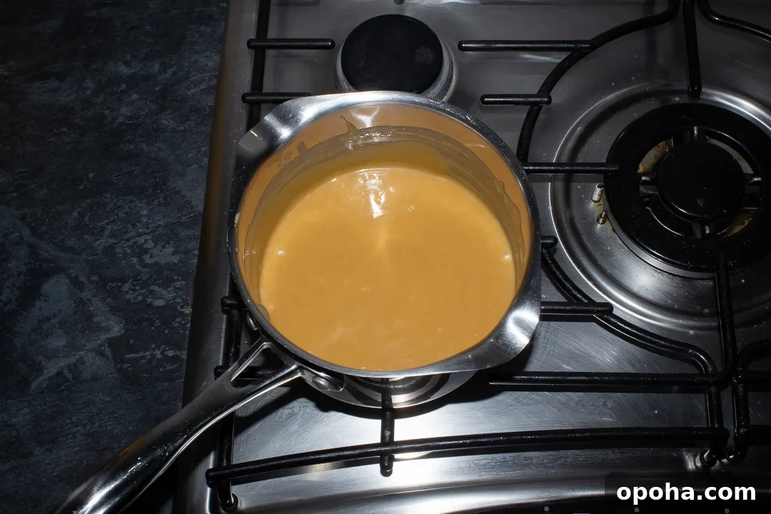 Halloween Millionaire Brownies: Rich Chocolate Caramel Treats 18 Cooked caramel in a saucepan on a stove top.