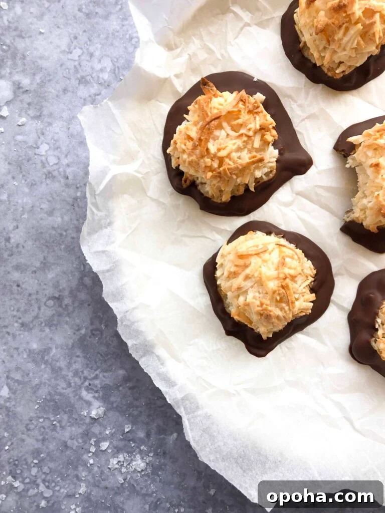 A plate of chocolate dipped coconut macaroons.