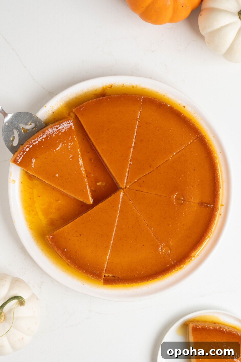 Sliced pumpkin flan on a white plate.