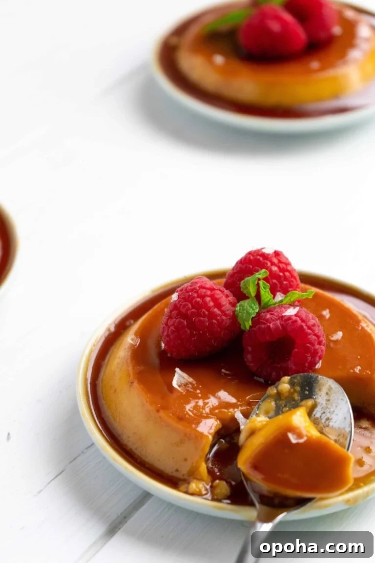 Puerto Rican Salted Coconut Flan on small plates with raspberries.