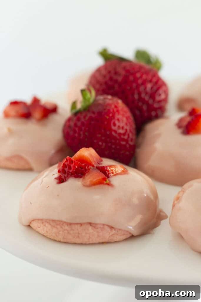 Strawberry cake mix cookies on a white cake plate.