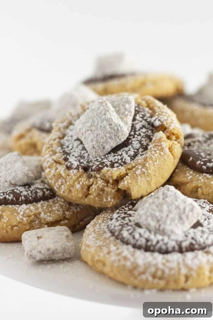 Muddy Buddy Cookies on a white cake plate.