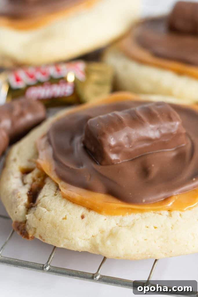 Cake Mix Cookies with Twix candy bars in and on them.