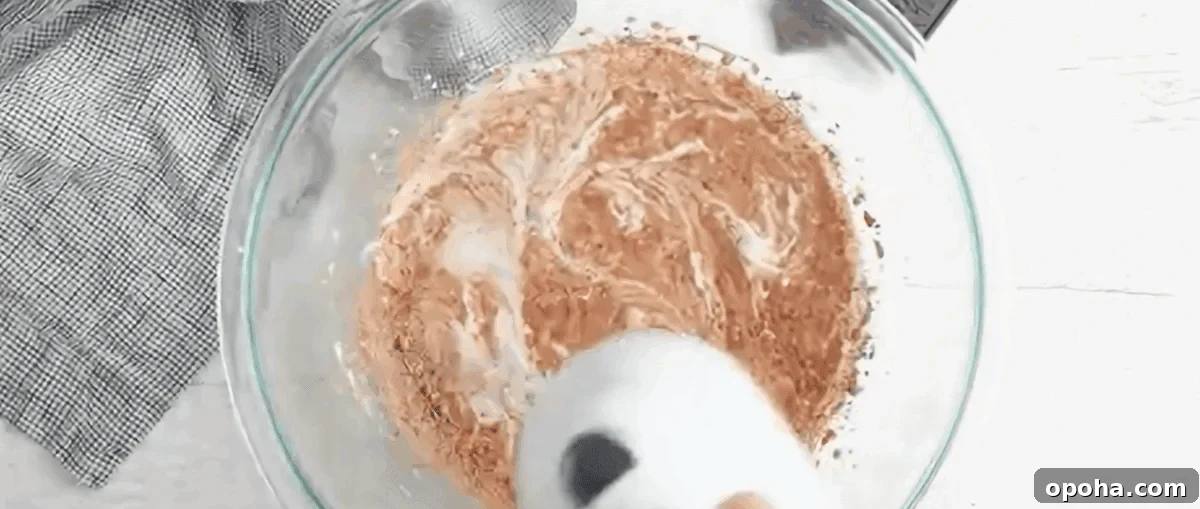 Decadent Chocolate Mousse Recipe You Can Make Tonight 6 Blending heavy cream and dry ingredients in a glass mixing bowl.