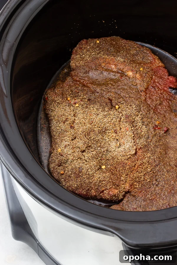 Slow Cooker & Instant Pot BBQ Pulled Beef Recipe (Shredded Beef) 4 A seasoned roast beef inside of a slow cooker