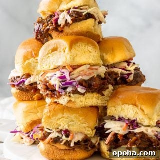 A plate of slow cooked bbq pulled beef inside of hamburger buns