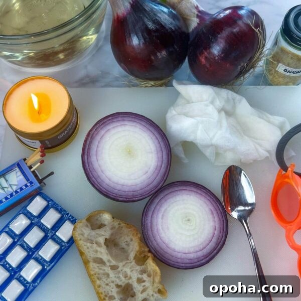 matches, gum, bread, spoon, swim goggles, candle and onions on white cutting board