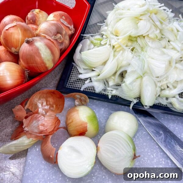 there are three piles of onions, some chopped, some whole with a knife and cutting board