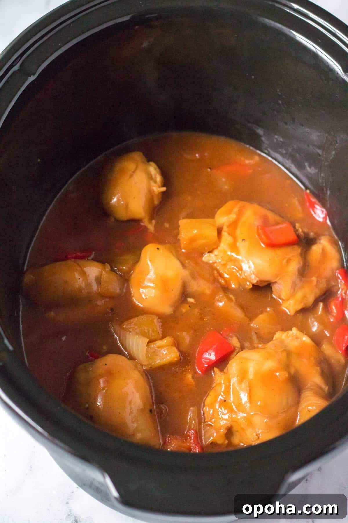 Slow Cooker Hawaiian Chicken with Pineapple and Sticky Sauce 5 Cooked chicken, pineapple and peppers in the slow cooker.