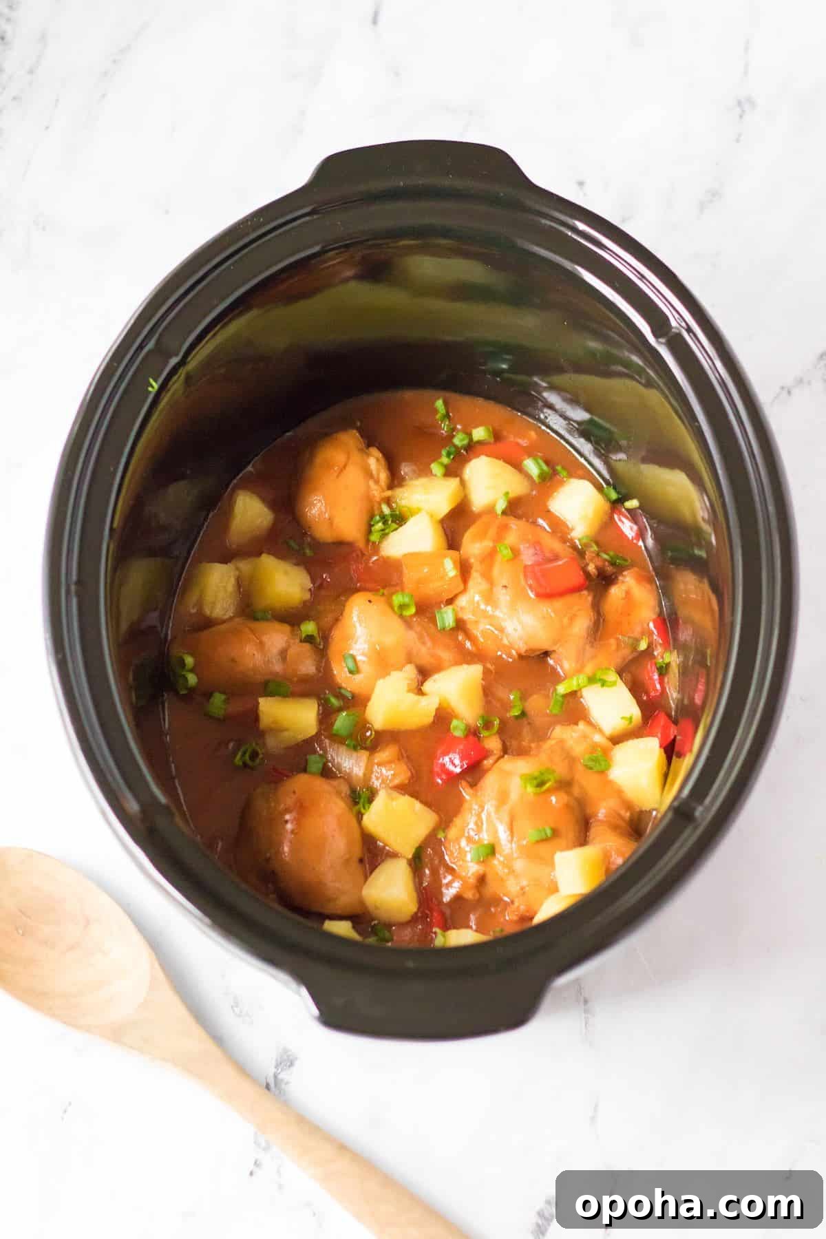 Slow Cooker Hawaiian Chicken with Pineapple and Sticky Sauce 6 Cooked Hawaiian chicken in the crockpot topped by sliced green onion.