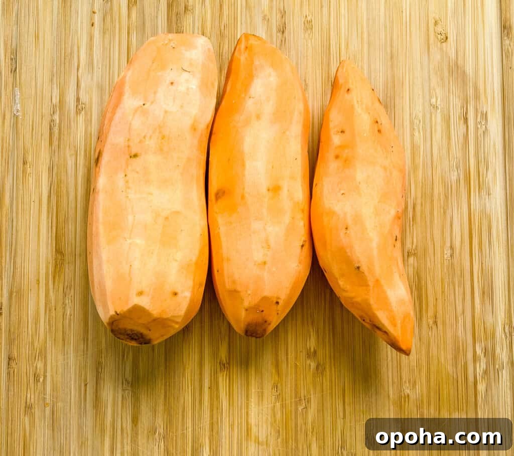 raw sweet potatoes on a cutting board