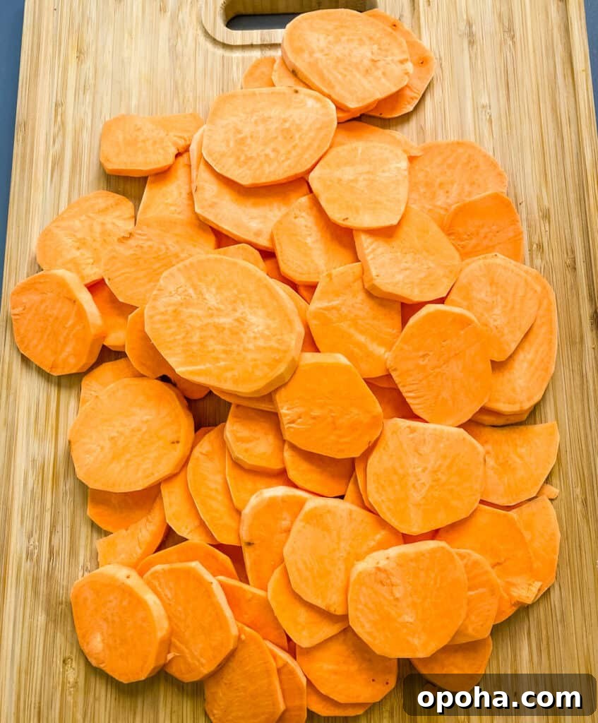 raw and sliced round sweet potatoes on a bamboo cutting board