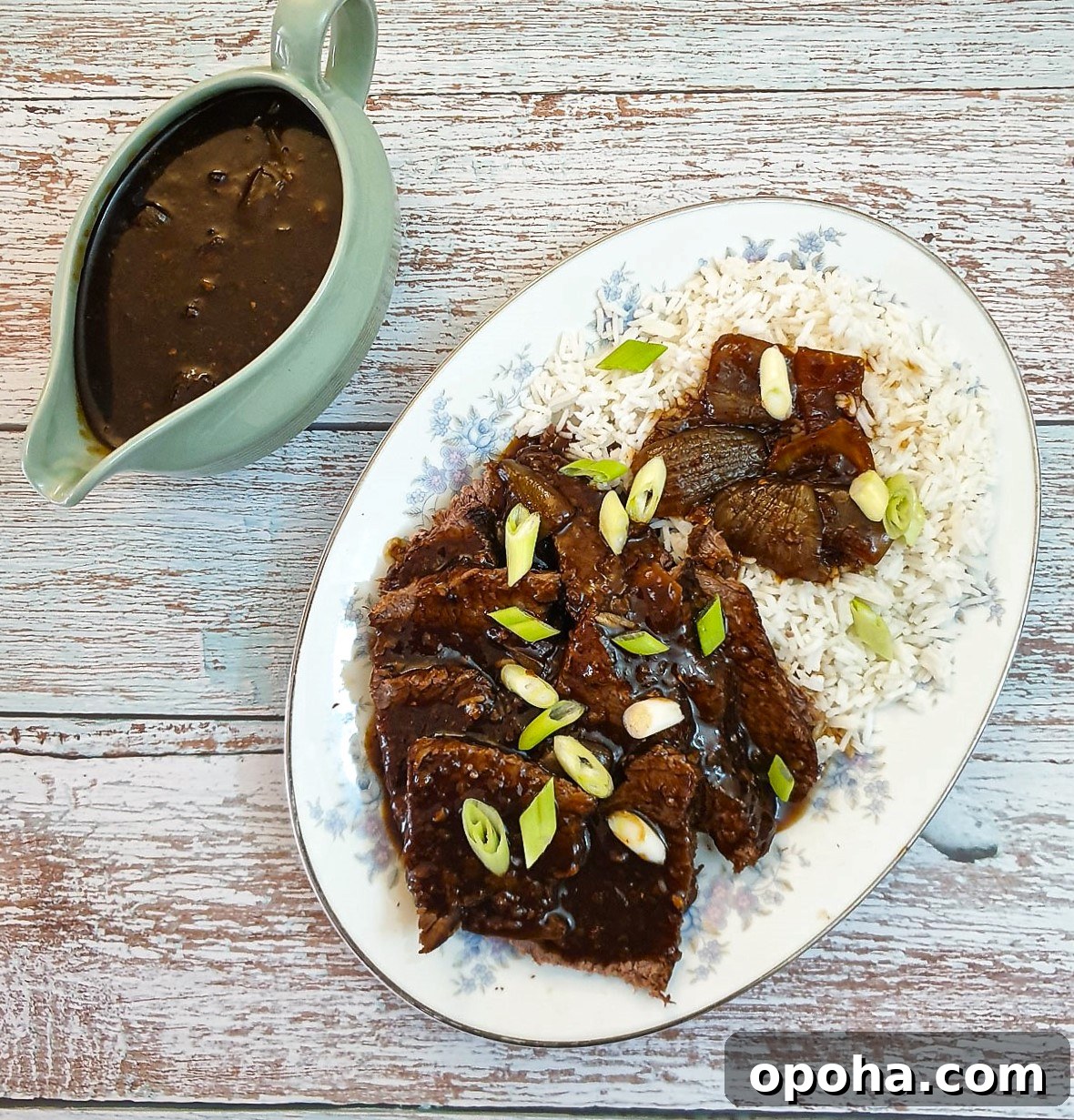 Slow-Cooker Mongolian Roast Beef Recipe for Tender, Savory Meat 2 Slices of slow-cooker mongolian roast beef on a bed of rice.
